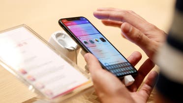 A customer tests the features of the newly launched iPhone X at VIVA telecommunication store in Manama, Bahrain, on November 3, 2017. (Reuters)