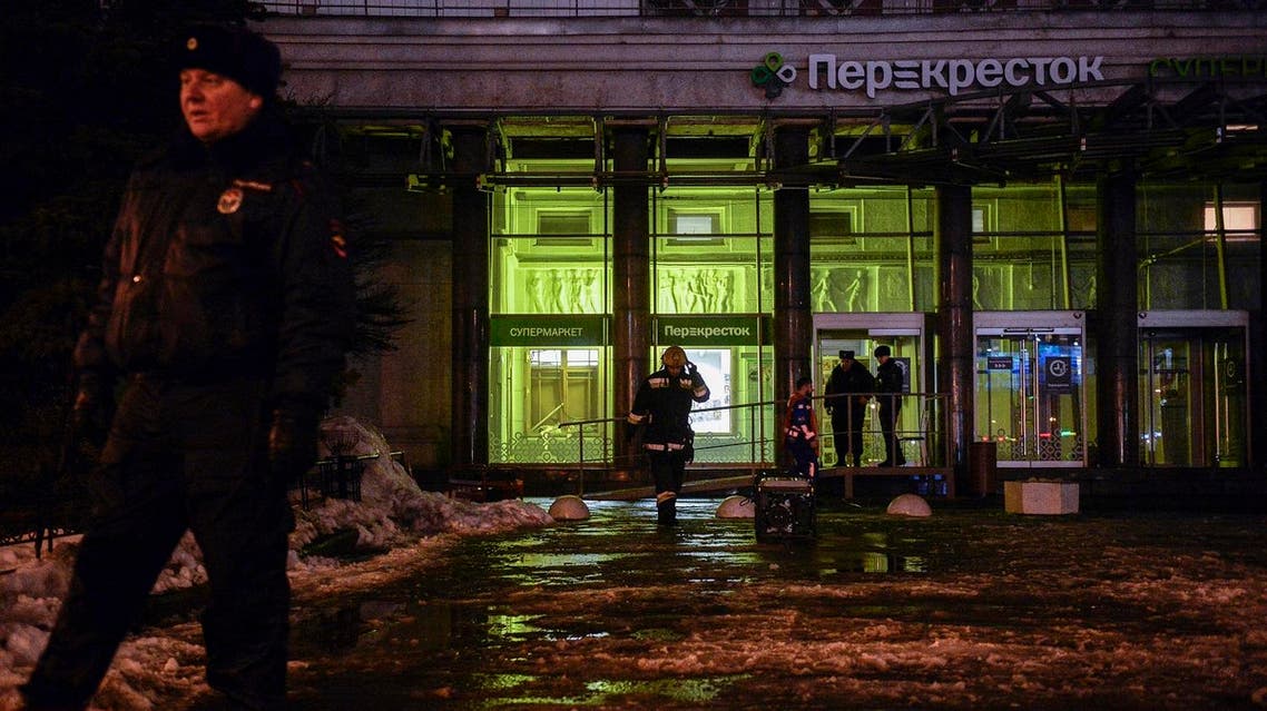 Firefighters and police officers work at the site of a blast in a supermarket in Saint Petersburg on December 27, 2017. (AFP)