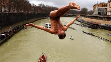 Marco Fois of Italy, dives in the Tiber river as part of traditional New Year celebrations on January 1, 2018 in Rome. (AFP)