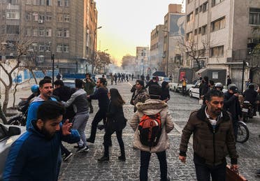 People are affected by tear gas fired by anti-riot Iranian police to disperse demonstrators in a protest over Iran's weak economy, in Tehran, Iran. (AP)