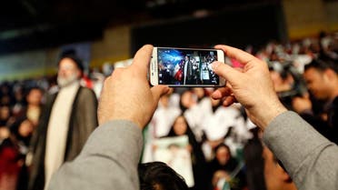 A supporter of Ebrahim Raisi takes a picture of the Iranian presidential candidate during a campaign rally in the capital Tehran on April 29, 2017. (AFP)