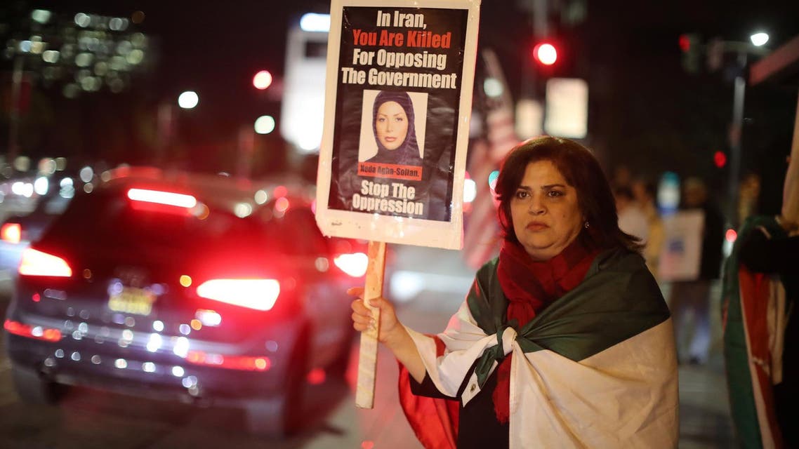 Iranian expatriate Roxanne Ganji holds a sign at a protest in Los Angeles on January 3, 2018. (Reuters)