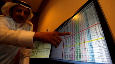 An investor gestures as he monitors a screen displaying stock information in Riyadh on November 6, 2017. (Reuters)