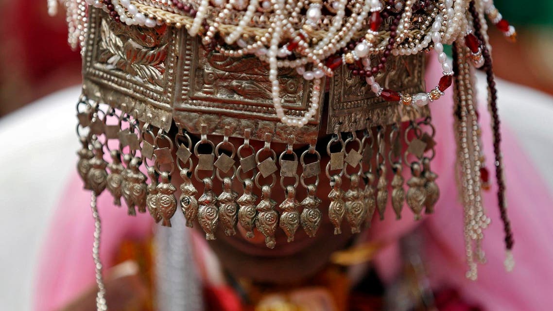 A groom wearing headgear attends a mass wedding ceremony in the old quarters of Delhi February 20, 2015. (Reuters)