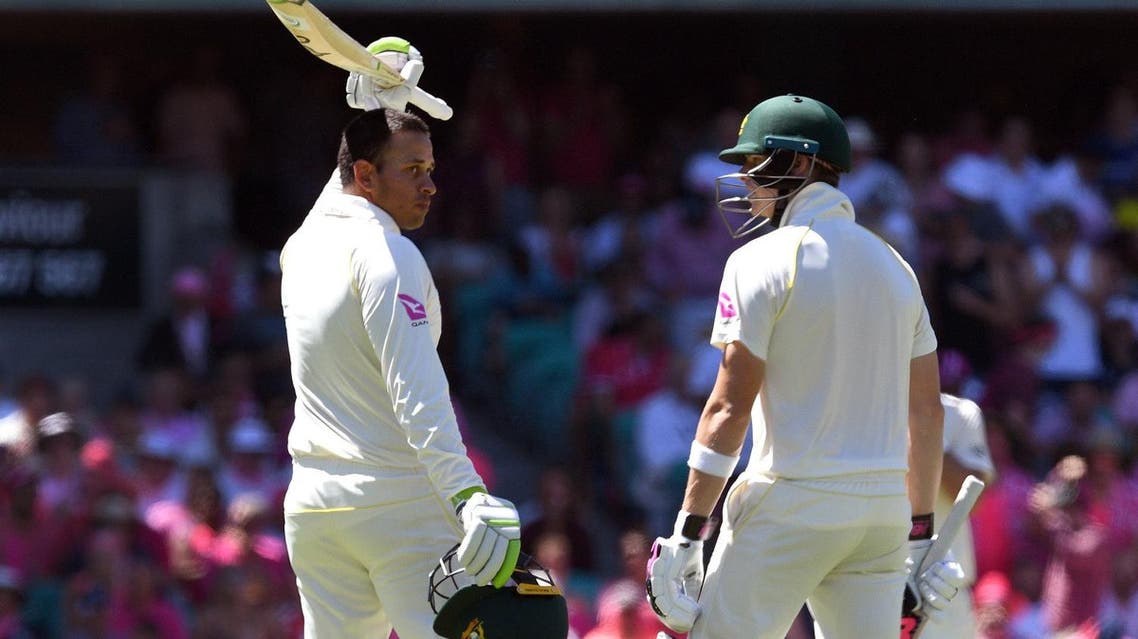 Australia’s Usman Khawaja (L) celebrates with teammate Steve Smith (R) after scoring his century against England on the third day of the fifth Ashes cricket Test match in Sydney on January 6, 2018. (AFP)