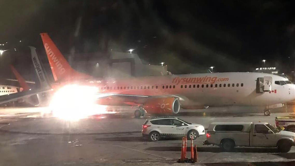 A picture obtained from the Facebook account of Connie Carson shows a Sunwing's airplene (front) colliding with a WestJet plane (L rear) on January 5, 2018, at Toronto's Pearson Airport. Both WestJet and Sunwing confirmed that their planes were involved in the collision. Video footage shared on social media appeared to show the tail of one aircraft aflame and spewing black smoke, and later images indicated that it was Sunwing's plane. Connie CARSON / FACEBOOK / AFP