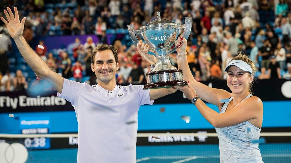 Roger Federer and Belinda Bencic of Switzerland celebrate winning the final at the Hopman Cup tennis tournament in Perth. (AP)