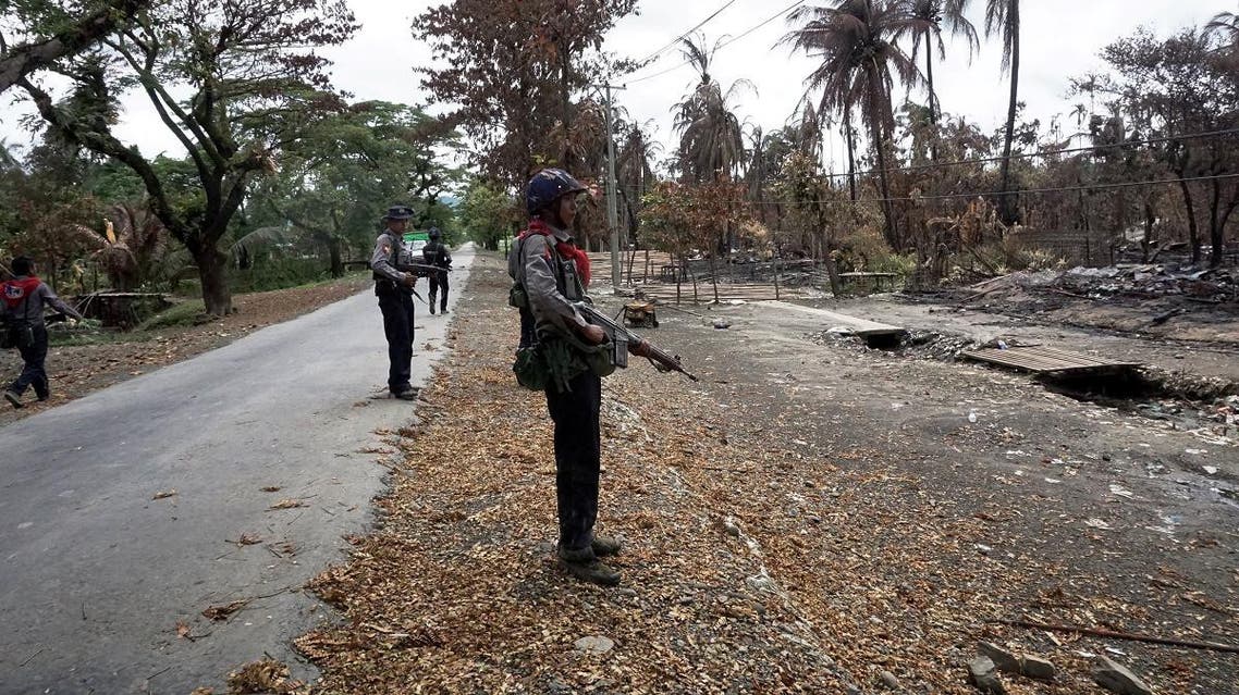 Myanmar policemen look at Myo Thu Gyi Muslim village where houses were burnt to the ground near Maungdaw town in northern Rakhine State. (AFP)
