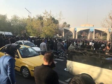 People protest near the university of Tehran on December 30, 2017 in this picture obtained from social media. (Reuters)