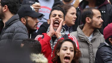 Demonstrating graduate shouts slogans during protests against rising prices and tax increases, in Tunis. (Reuters)