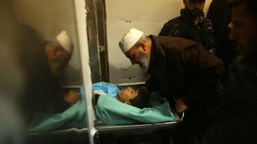 A relative mourns over the body of Palestinian teenager Amir Abu Musaid at the al-Aqsa hospital in Deir el-Balah, in the central Gaza Strip, after he was shot dead in clashes with the Israeli military along the Gaza border on January 11, 2018. (AFP)
