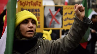 A protester raises her fist during a demonstration in support of the Iranian people amid a wave of protests spreading throughout Iran, on January 5, 2018, in Paris. (AFP)