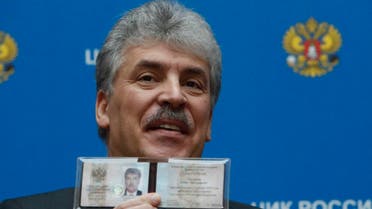 Businessman Pavel Grudinin, representing the Russian Communist Party, demonstrates his identity document after he was registered as a candidate in the upcoming presidential election the Central Election Commission headquarters in Moscow, Russia January 12, 2018. (Reuters)