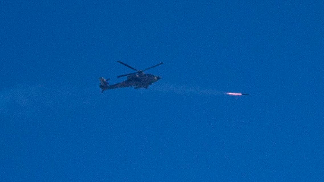 An Israeli Apache attack helicopter fires a missile over the Gaza Strip as seen from Israel's border with Gaza, on July 24, 2014. (AFP)