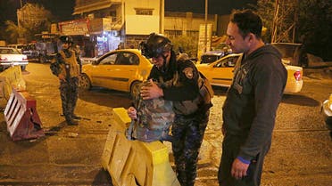 Iraqi security forces working at the scene of a suicide bombing in Baghdad on Jan. 13, 2018. (AP)