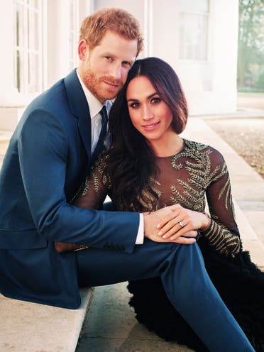 A handout picture released on December 21, 2017 by Kensington Palace shows Prince Harry posing with Meghan Markle at Frogmore House in Windsor. (AFP)