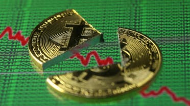 Broken representation of the Bitcoin virtual currency, placed on a monitor that displays stock graph and binary codes, are seen in this illustration picture. (Reuters)
