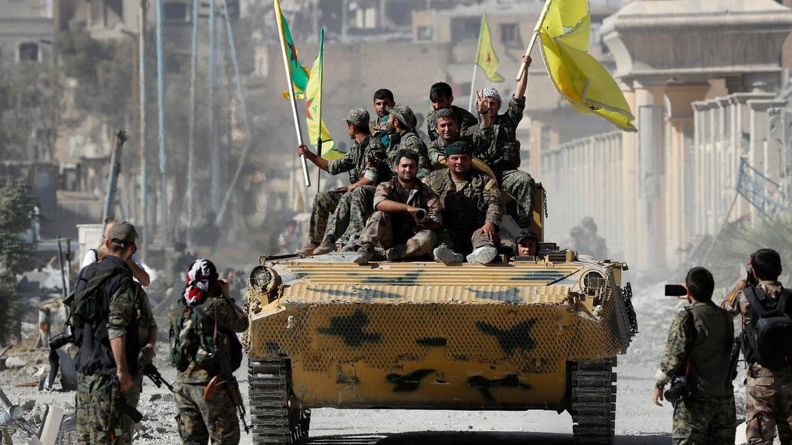 Fighters of Syrian Democratic Forces ride atop of an armored vehicle after Raqqa was liberated from ISIS militants, in Raqqa, on October 17, 2017. (Reuters)