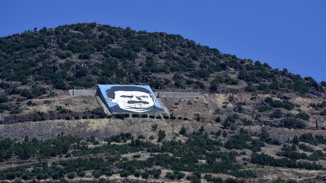A picture taken on June 9, 2017 from the city of Afrin, along Syria's northern border with Turkey, shows a portrait of jailed Kurdish leader Abdullah Ocalan. (AFP)