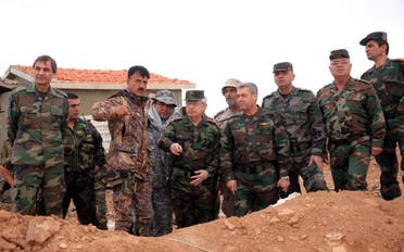 A handout picture released by the Syiran Arab News Agency (SANA) shows Chief of the General Staff of the Syrian Army Ali Abdullah Ayyoub (C), accompanied by a number of senior army officers during fighting in 2014. (AFP, SANA)