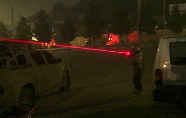 A security personnel points his weapon near the Intercontinental Hotel after a deadly attack in Kabul. (AP)