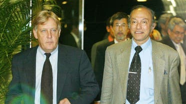 Head of the Free Aceh Movement (GAM) Malik Mahmud (R) is escorted by a mediator and chief of the Henry Dunant Center Martin Griffiths (L). (File photo: AFP)