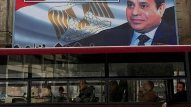 A transport bus passes in front of a banner advertising Egyptian President Abdel Fattah al-Sisi’s electoral campaign in Cairo on January 22, 2018. (Reuters)
