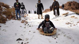 PHOTOS: Families enjoy day of sledding as snow drapes Saudi Arabian mountains