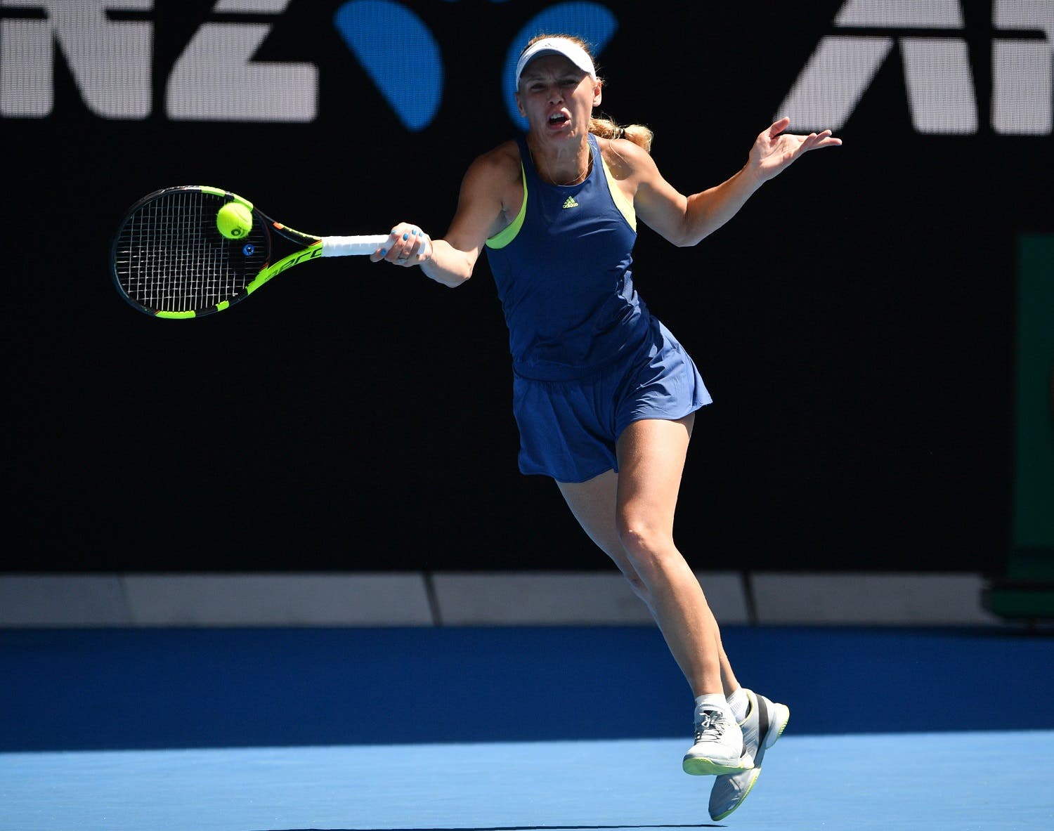 Caroline Wozniacki hits a return against Elise Mertens during their women’s singles semi-finals match of the Australian Open tennis tournament on January 25, 2018. (AFP)