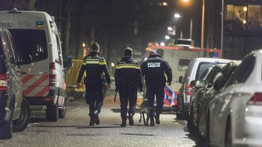 Policemen patrol a closed off lane following a shooting at the Grote Wittenburgstraat in Amsterdam on January 26, 2018. (AFP)