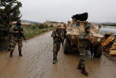 Members of Turkey-backed Free Syrian Army police forces secure the road as they escort a convoy near Azaz, Syria January 26, 2018. (Reuters)