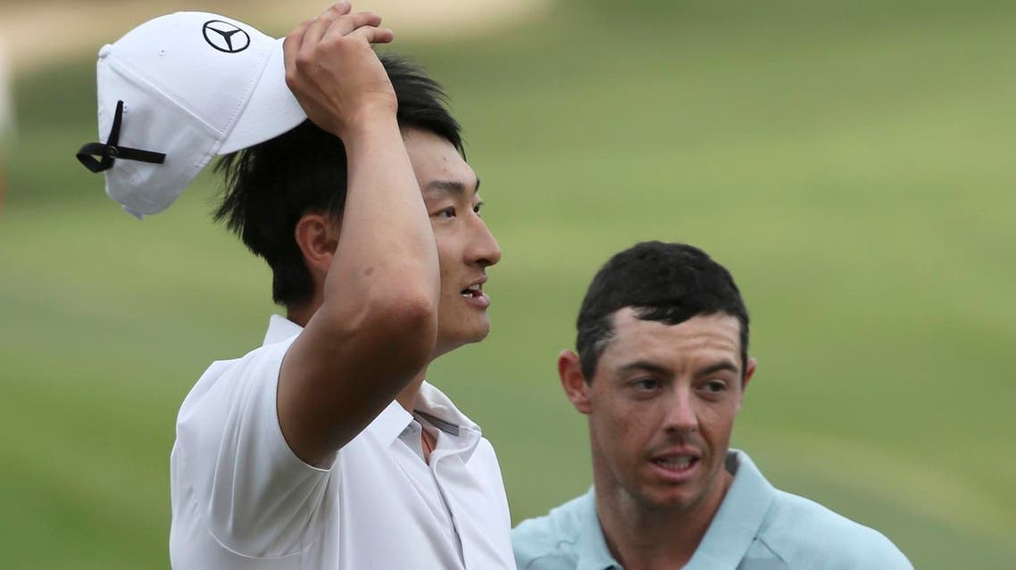 China’s Li Haotong (left), and Northern Ireland’s Rory McIlroy react after Li Haotong won the Dubai Desert Classic golf tournament in Dubai. (AP)