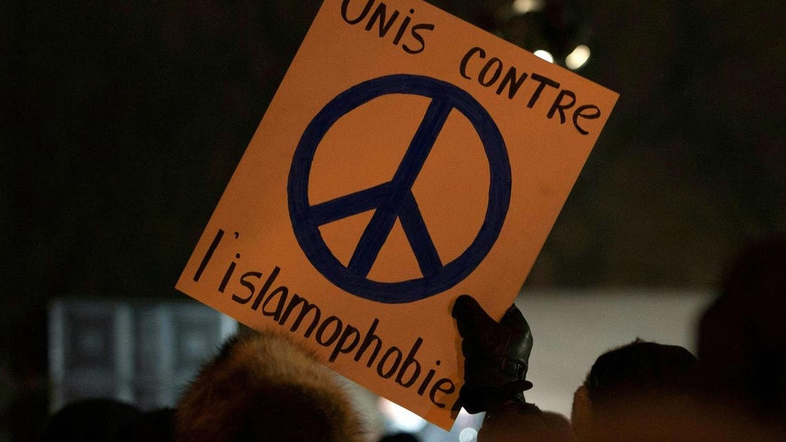 A person holds a sign "United against Islamophobia" during a rally near the Islamic Cultural Center in Quebec City, Canada on January 30, 2017. (AFP)