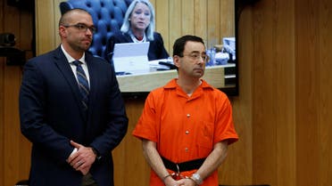 Larry Nassar, a former team USA Gymnastics doctor who pleaded guilty in November 2017 to sexual assault charges, stands with his attorney Matt Newburg as Judge Janice Cunningham (seen on screen) gives instructions during Nassar's second sentencing in the Eaton County Circuit Court in Charlotte, Michigan, U.S., January 31, 2018. REUTERS/Rebecca Cook