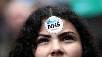 Thousands march to demand more money for UK health service