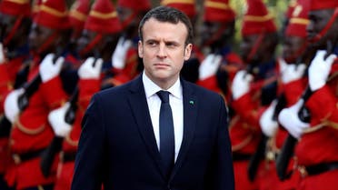 French President Emmanuel Macron reviews troops during a ceremony at the presidential palace before a meeting with Senegalese President in Dakar. (Reuters)