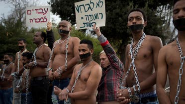 Eritrean migrants wear chains to mimic slaves at a demonstration against the Israeli government's policy to forcibly deport African refugees and asylum seekers in Jerusalem. (AP)