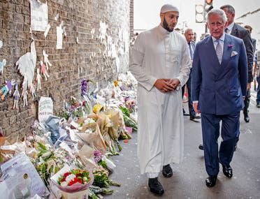 Britain's Prince Charles, Prince of Wales (R) and Imam Mohammed Mahmoud (L) visit floral tributes left close to the scene of the Finsbury Mosque attack in the Finsbury Park area of north London on June 21, 2017. (AFP)
