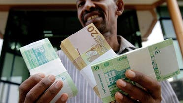 A Sudanese man shows freshly-minted notes of the new Sudanese pound in Khartoum. (AFP)