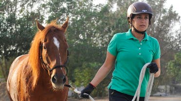 Saudi Dana al-Gosaibi walks a horse during a training session. (AFP)