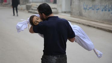 A Syrian father kisses the body of his daughter, 6-year-old Aya, ahead of her funeral in Zamalka, near Syria's capital Damascus. (AFP)