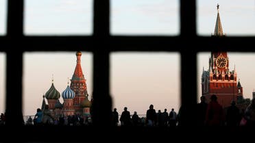 FILE PHOTO: Red Square, St. Basil's Cathedral (L) and the Spasskaya Tower of the Kremlin are seen through a gate in central Moscow, September 18, 2014. Picture taken September 18, 2014. REUTERS/Maxim Zmeyev/File Photo