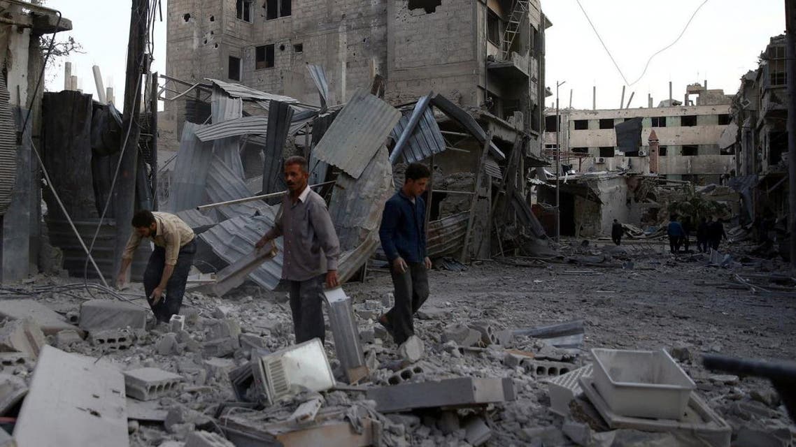 Men inspect damages after an airstrike on the rebel-held city of Douma, in the eastern Damascus suburb of Ghouta, Syria November 2, 2017. REUTERS