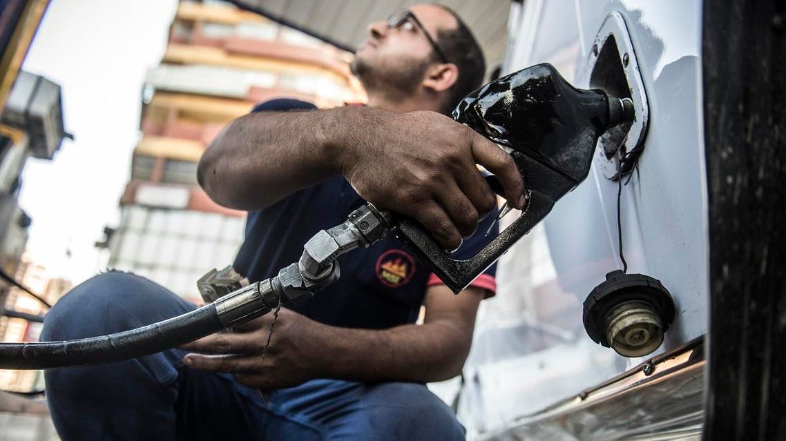 An Egyptian petrol station worker fills up a vehicle's tank in the capital Cairo on June 29, 2017. (AFP)