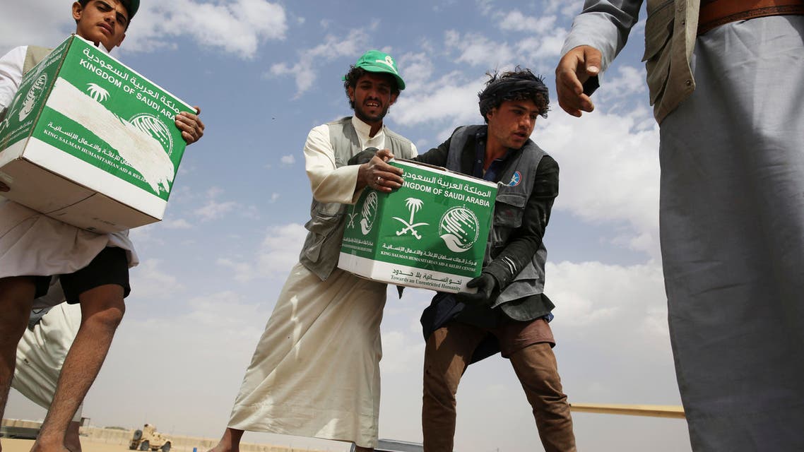 relief workers unload aid carried into Yemen by the Saudi military in Marib, Yemen. (AP)