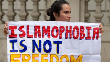 A protester holds a sign which reads “Islamophobia is not freedom” outside the French Embassy in London on August 25, 2016. (AFP)