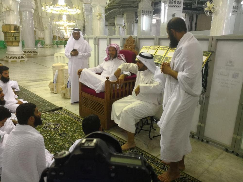 A religious scholar answers questions from people with hearing disabilities. (Saudi Gazette)