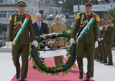 Palestinian Prime Minister Rami Hamdallah, (left), escorts Indian Prime Minister Modi while he lays a wreath on Arafat’s grave. (AP)