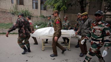 Indian army soldiers carry the body of their colleague who was killed in an attack on an army camp, on a stretcher outside a hospital in Jammu on February 11, 2018. (Reuters)