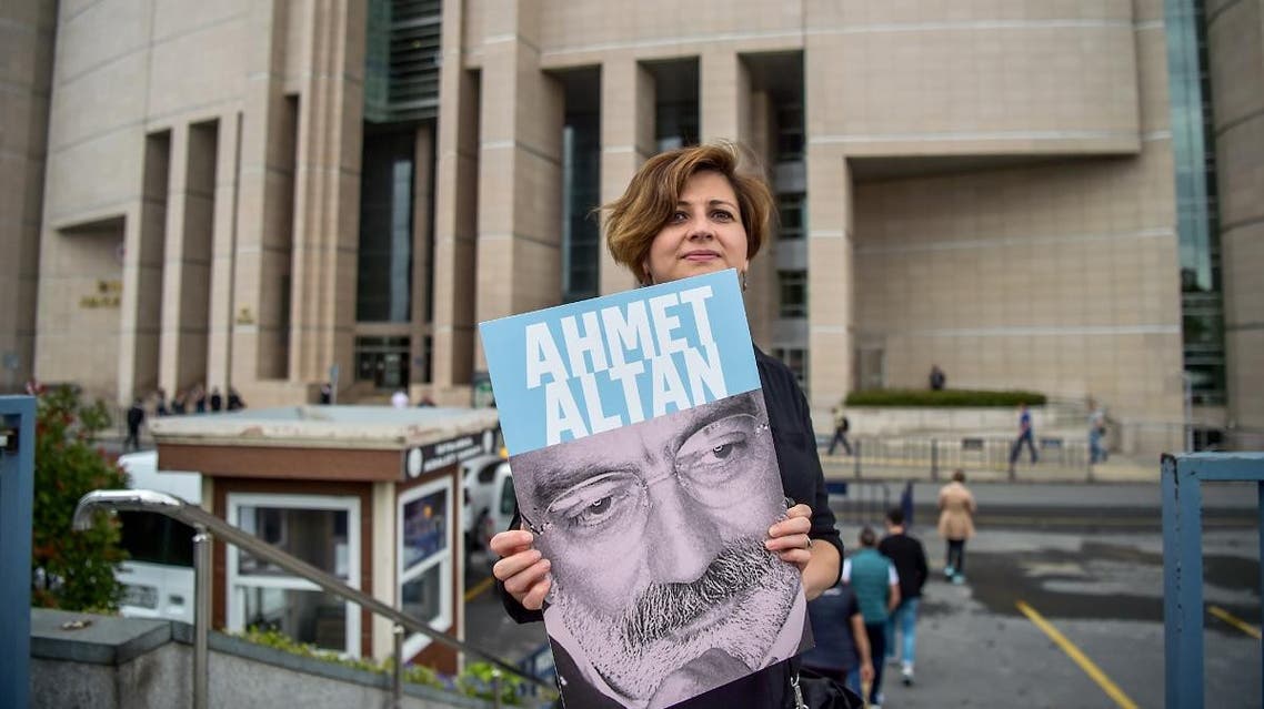 A journalist poses with a portrait of Turkish journalist Ahmet Altan in front of the Istanbul courthouse. (AFP)
